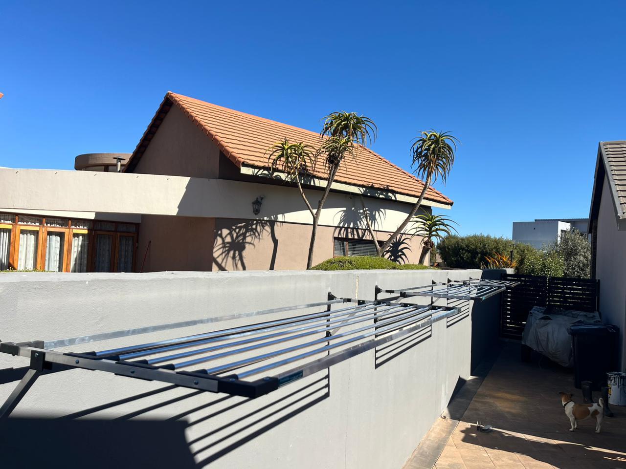 After ProHang Installation - Professional aluminum washing line system with clean, organized space