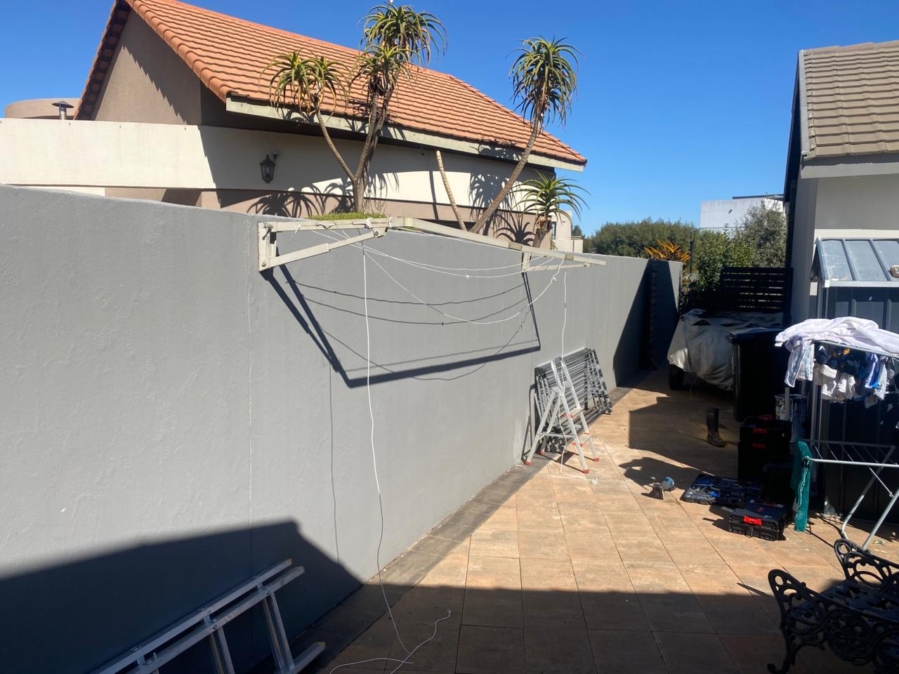Before ProHang Installation - Traditional washing line setup showing cluttered and inefficient space usage